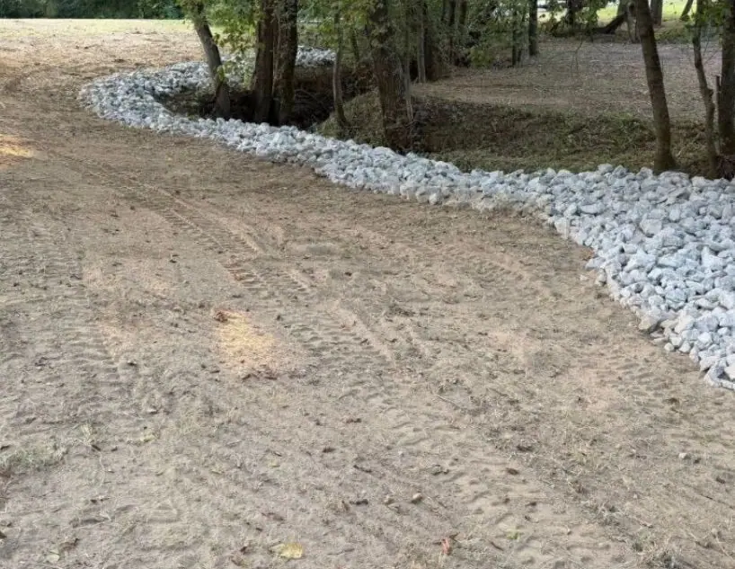 Creek bank after: graded and lined with riprap rock